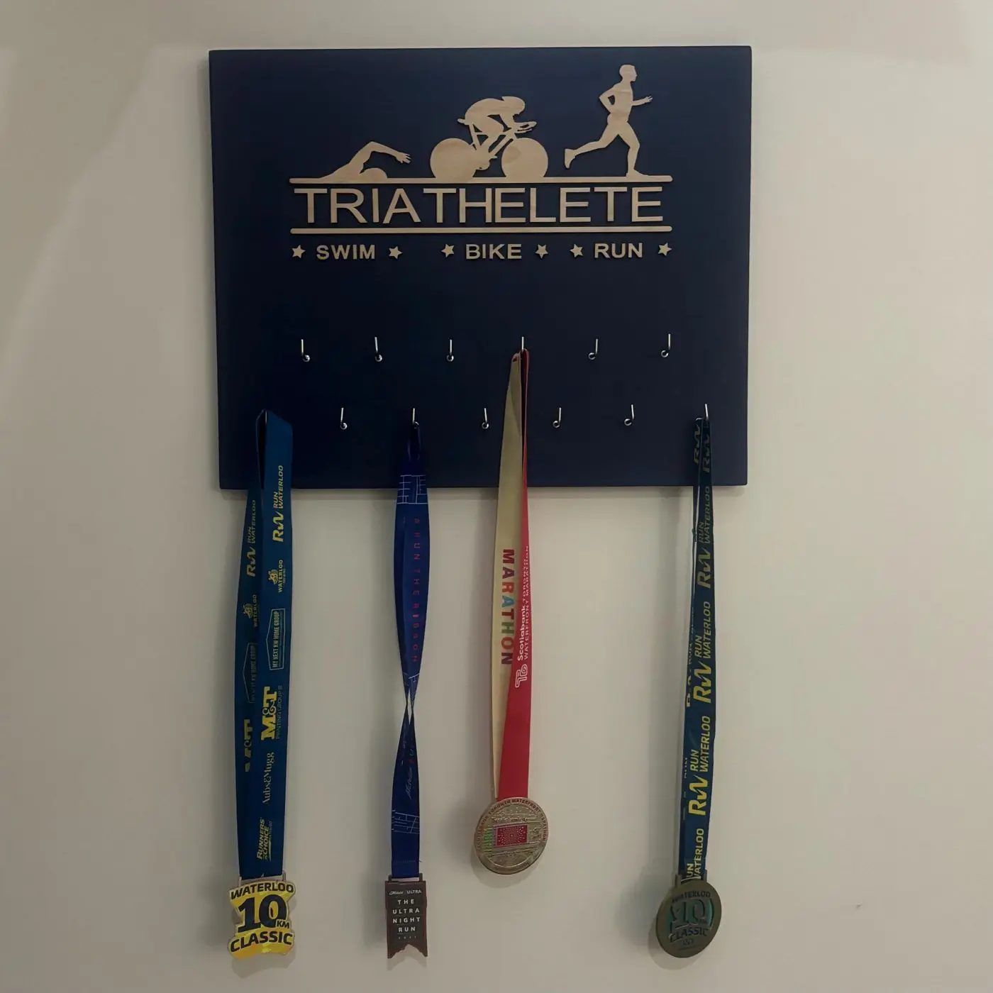 Custom race medal display with a bib slot and a finisher medal, Waterloo